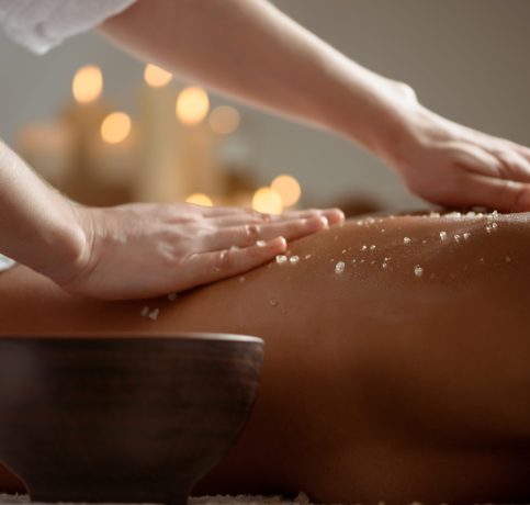 Young beautiful brunette girl relaxing in spa salon. Copy space.