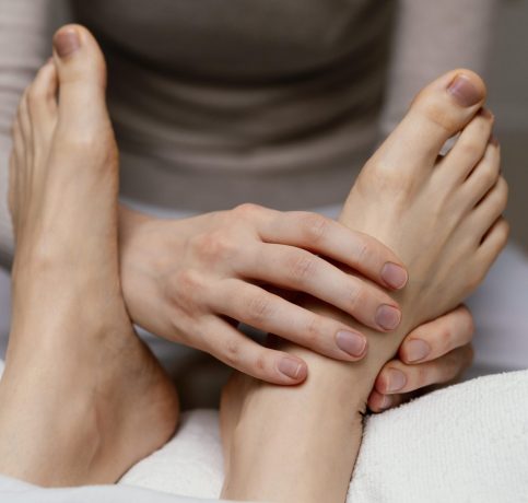 close-up-therapist-massaging-foot